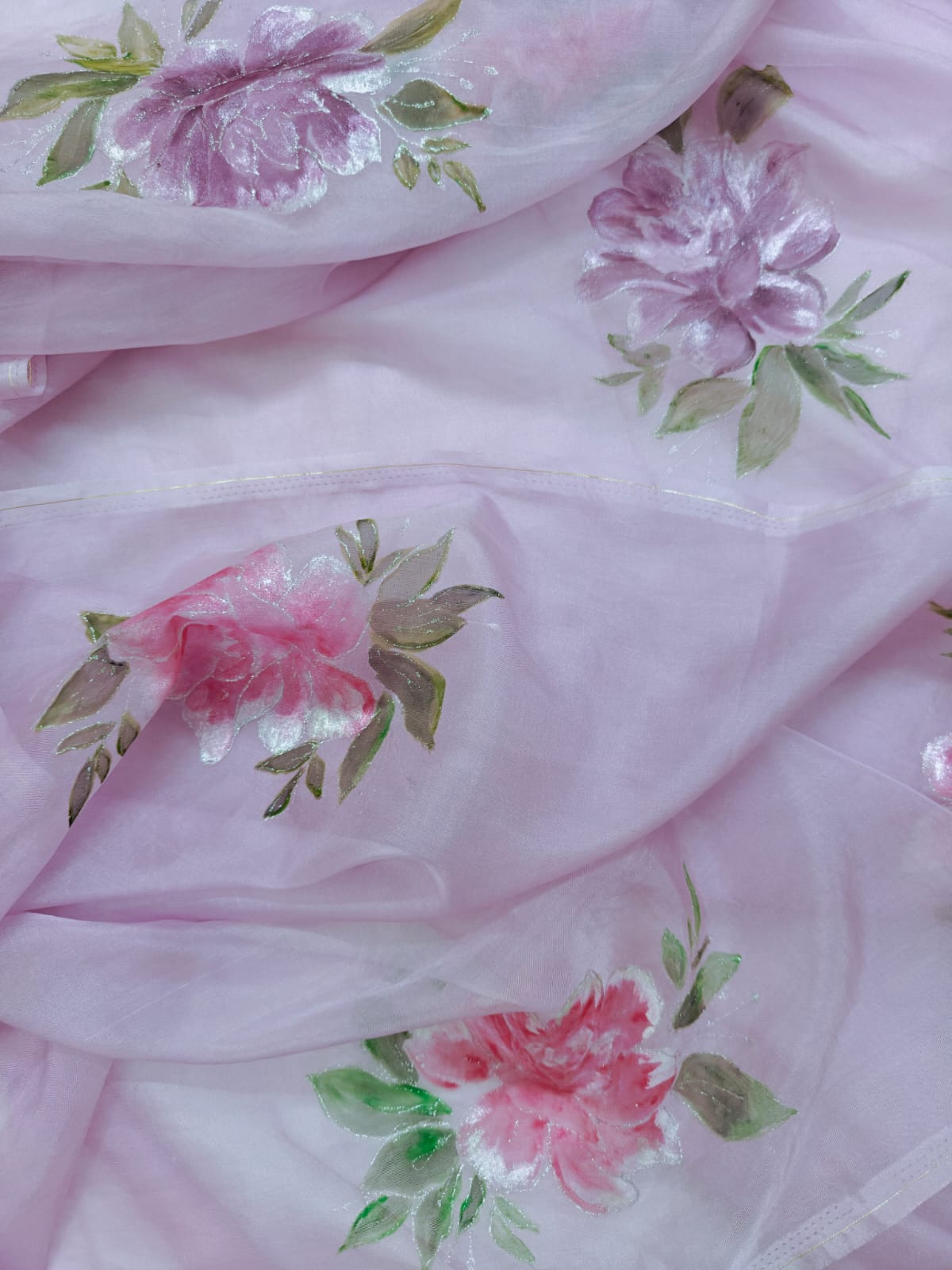 Blush pink hand-painted organza saree with floral motifs