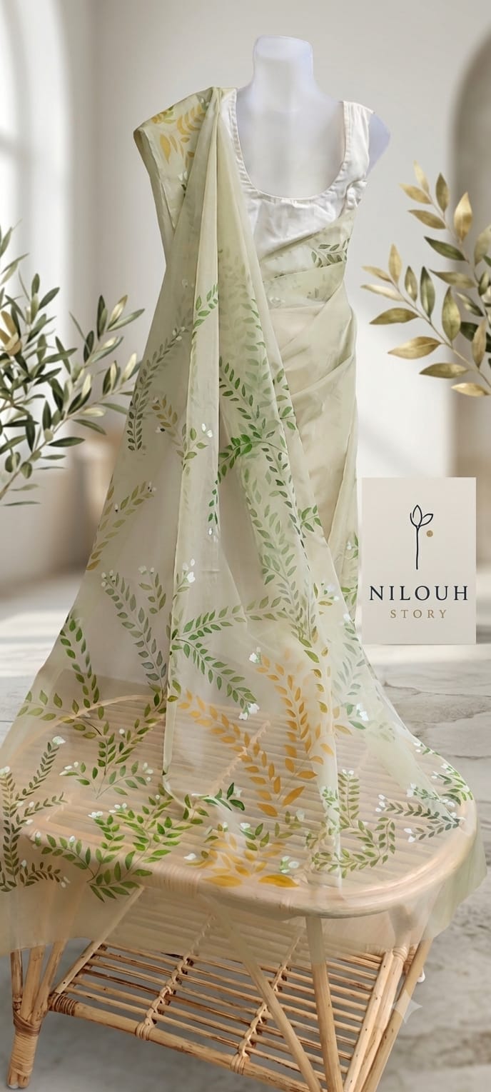 Olive green organza saree draped on mannequin