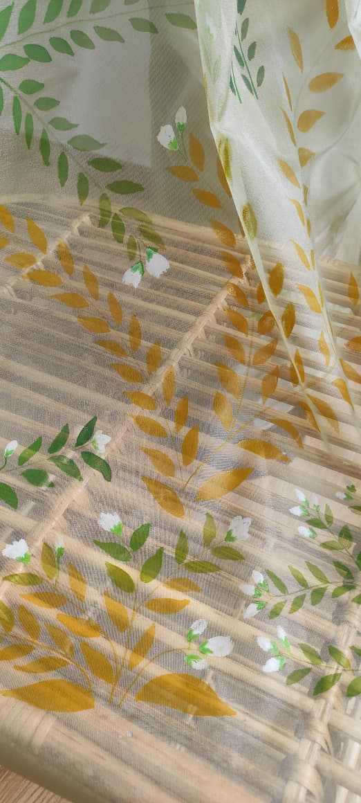 Close view of the hand-painted botanical organza fabric