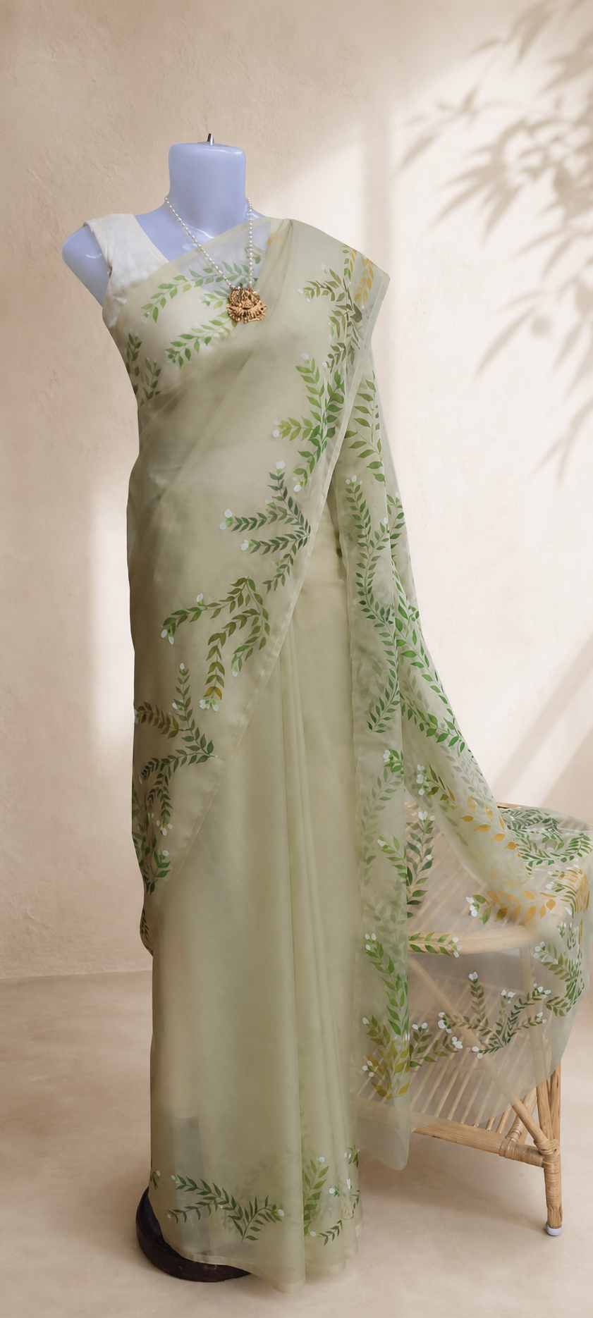 Olive green hand-painted organza saree in a soft studio setting